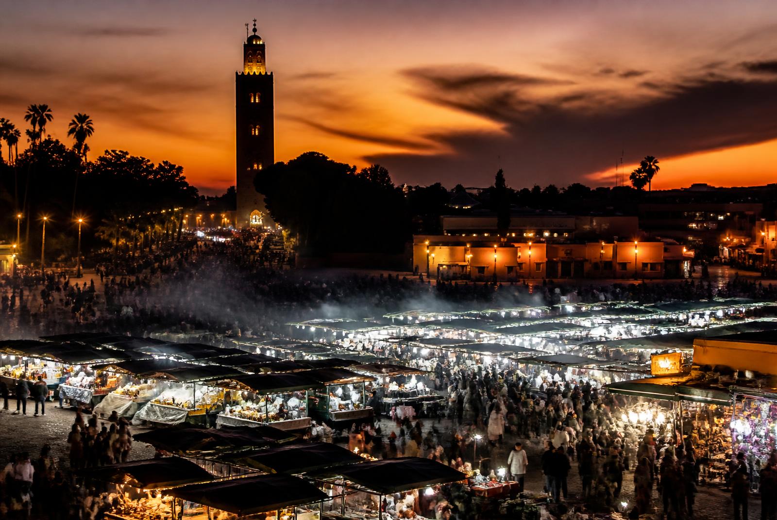 Rooftop view over the Medina of Marrakech at sunset with the Koutoubia minaret